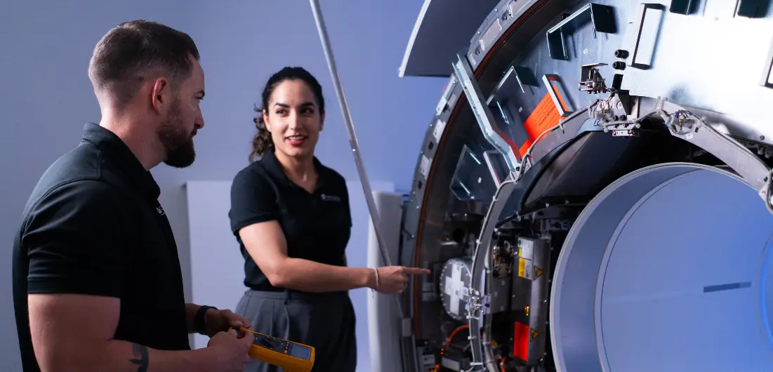 Technologist reviewing imaging results with patient in Siemens Healthineers scanner representing Naples medical imaging solutions